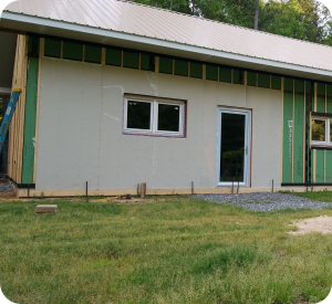BuildSMART-Building-SMART-Build-SMART-J-Form-Underslab-Insulation-Vapor-Barrier-Gravel-Bed-and-concrete-slab-on-grade-contractor-Horizontal-Wing-Insulation-high-performance-wall-panel-building-envelope-E-Wall-buildsmartna.com-Passive-House-energy-efficiency-net-zero-J-Form-insulated-permanent-shallow-foundation-Form-System-prefabrication-prefab-modular-construction-Developer-Architect-Builder-Homeowner-Exterior-Wall-Panel-Interior-Frame-Walls-Single-Family-Multifamily-Senior-Living-Assisted-Care-Daycare-Clinic-Student-Living-School-Office-Hospitality-Mixed-Use-Slab-On-Grade-Crawl-Space-Basement-Piers-Column-Walk-Out-Basement-Energy-Star-LEED-WELL-Living-Building-Challenge-FORTIFIED-Thermal-Efficiency-Labor-Savings-Low-risk-air-barrier-and-very-low-infiltration-rates-severe-weather-survivability-sound-attenuation-and-a-quiet-secure-feeling-inside-low-cost-of-ownership-optimized-construction-cost-and-operation-cost-total-cost-of-ownership-optimized-cash-flow-and-return-on-investment-construction-drawings-Floor-Plans-scale-and-dimension- Elevations-Wall-Section-Window-Door-Schedule-Section Details-Lender-Structural Engineer-MEP Engineer-Energy Modeler-Energy-Rater-Resilience-zero-carbon-Panelized-Passive-House-Multifamily-Prefabricated-Modular-Offsite-construction-Off-site-construction-Code-comparison-Financial-analysis-Return-on-investment-ROI-Internal-rate-of-return-IRR-Real-estate-valuation-Cash-flow-Pro-forma-Financial-terms-in-attached-documents-Noise-Sound-proofing-NIMBY-Health -Ventilation-Section-8-Voucher-program-Build-to-Rent-All-AIA-education-credits-Health-Safety-Welfare-credits-HSW-NIMBY-Ventilation-Noise-Soundproofing